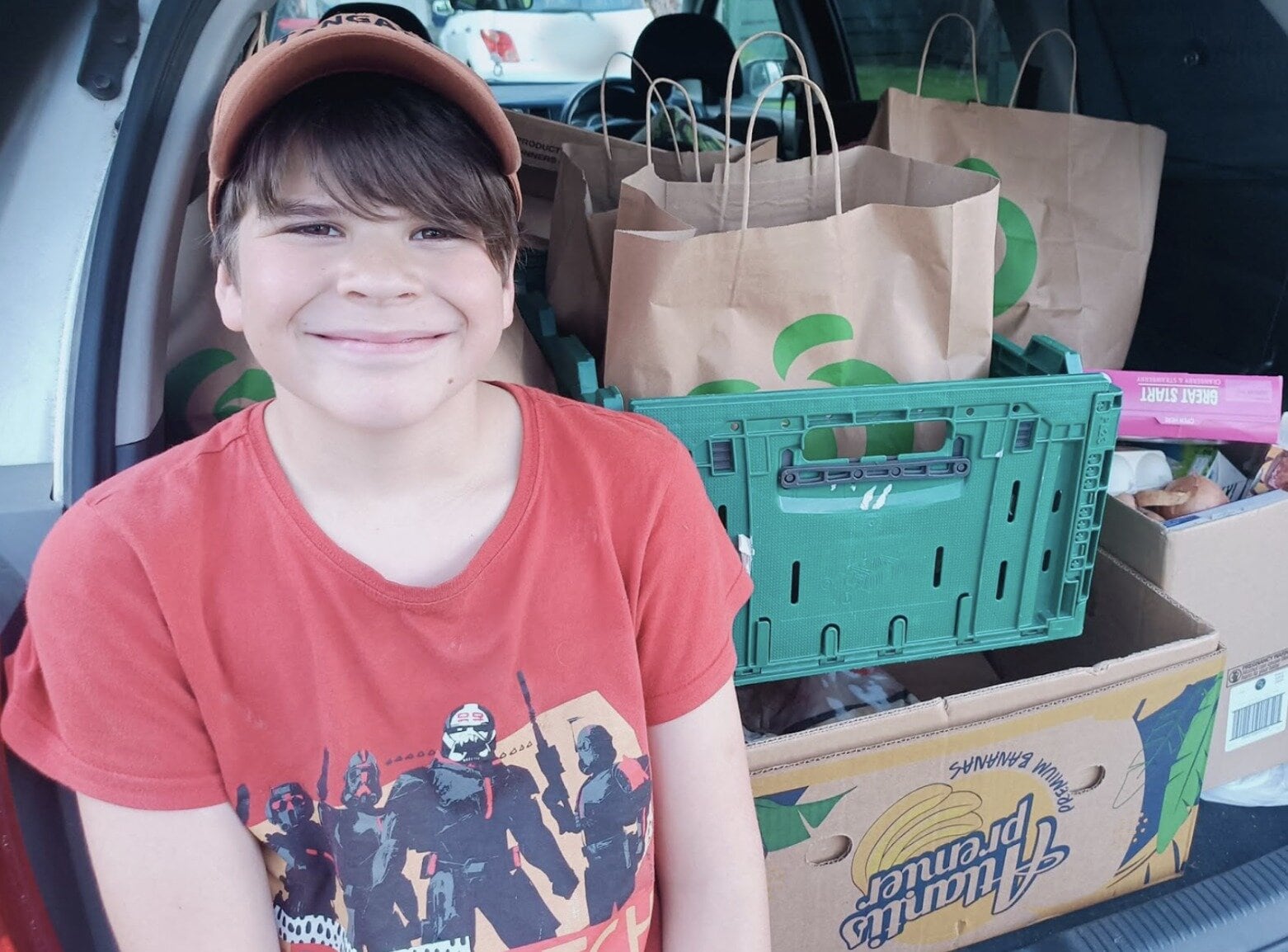  Emily-Kay’s son, Tamahau, distributing food parcels to whānau in need. Photo / Emily-Kay Livick