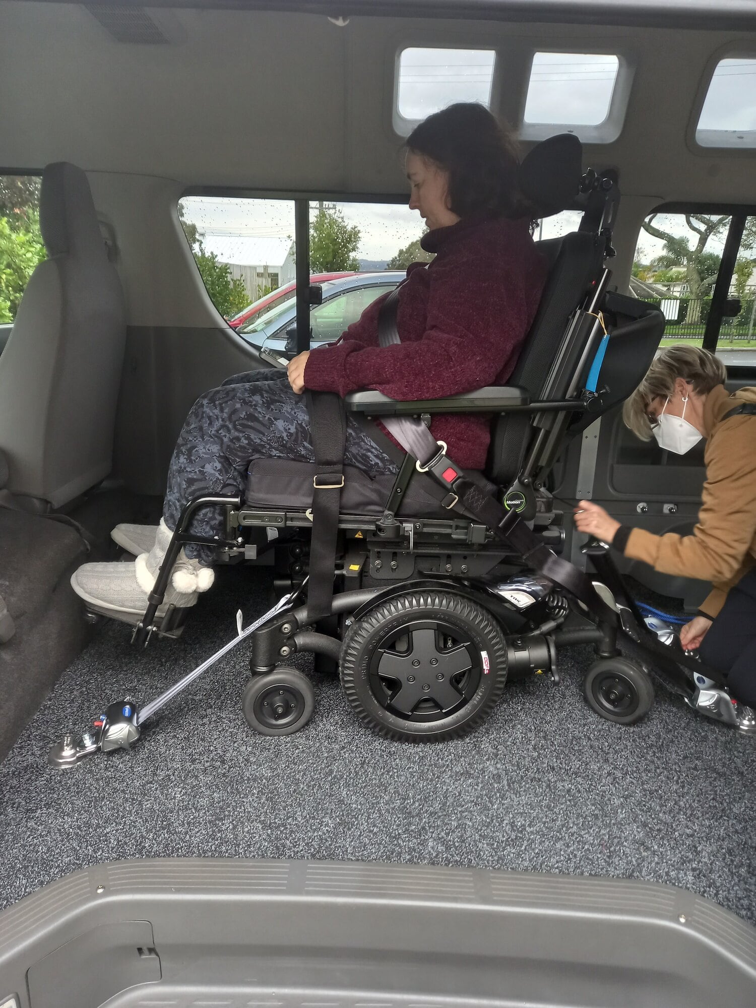 Michelle's power chair being strapped into her mobility van.