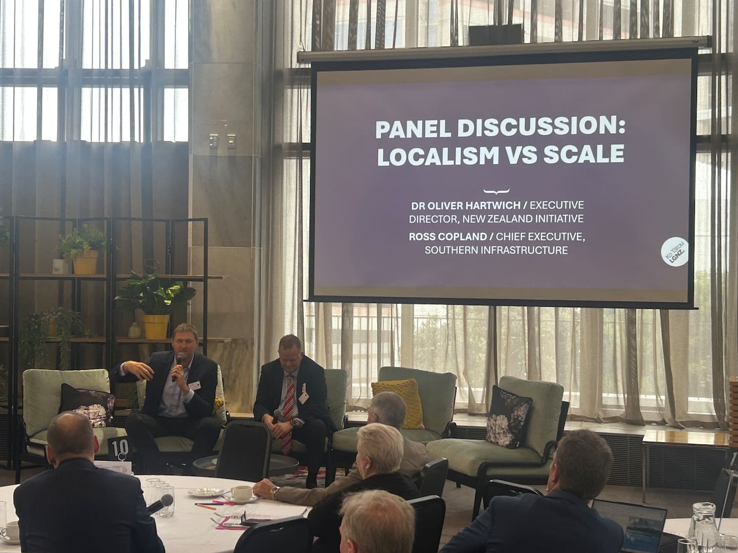 Dr Oliver Hartwich (right), of the New Zealand Initiative, and Southern Infrastructure chief Ross Copland speak at a local government conference at Parliament. Photo / Adam Pearse