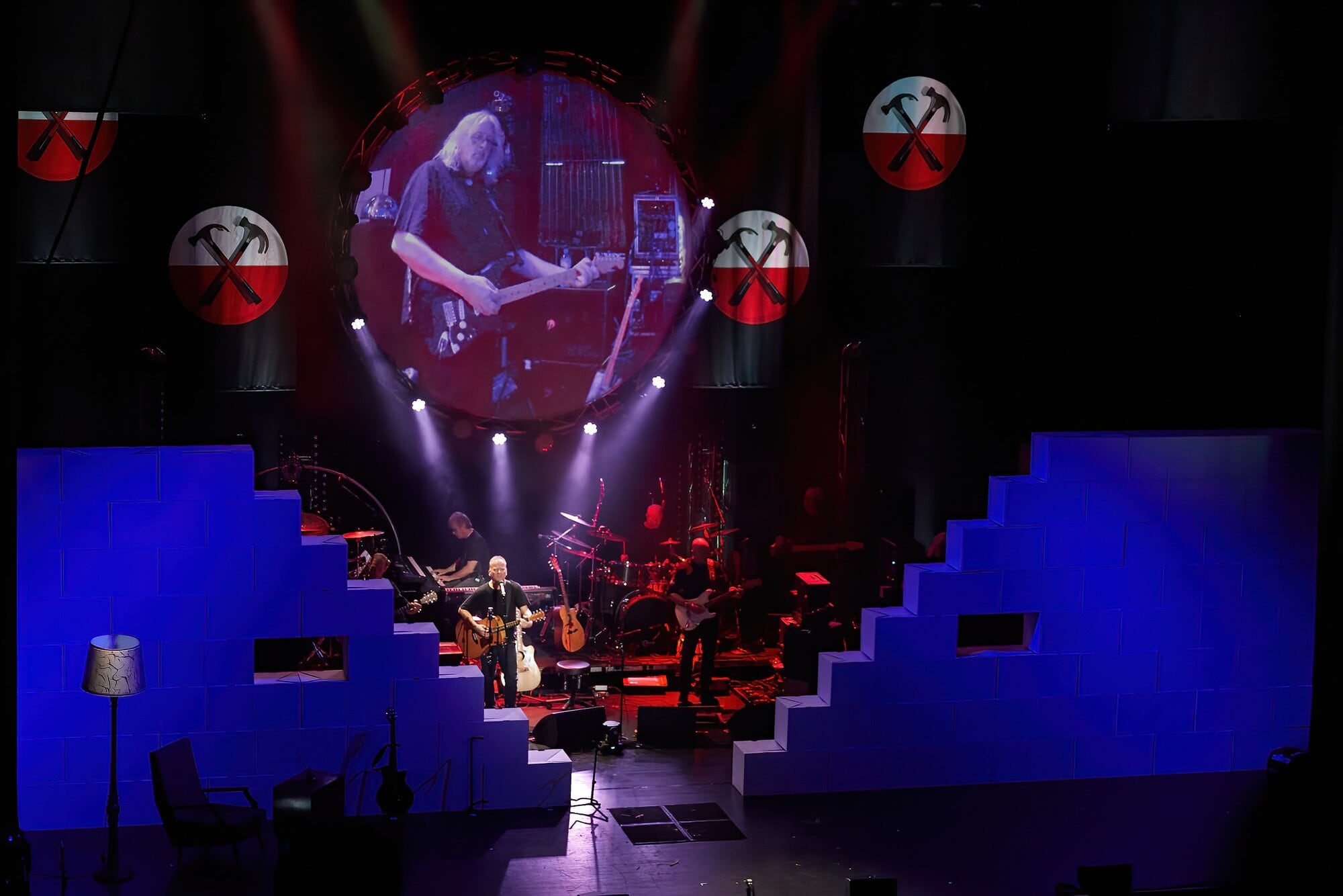 Marty highlighted on the big screen as The Wall is constructed during a Pink Floyd Experience show. Photo / Supplied