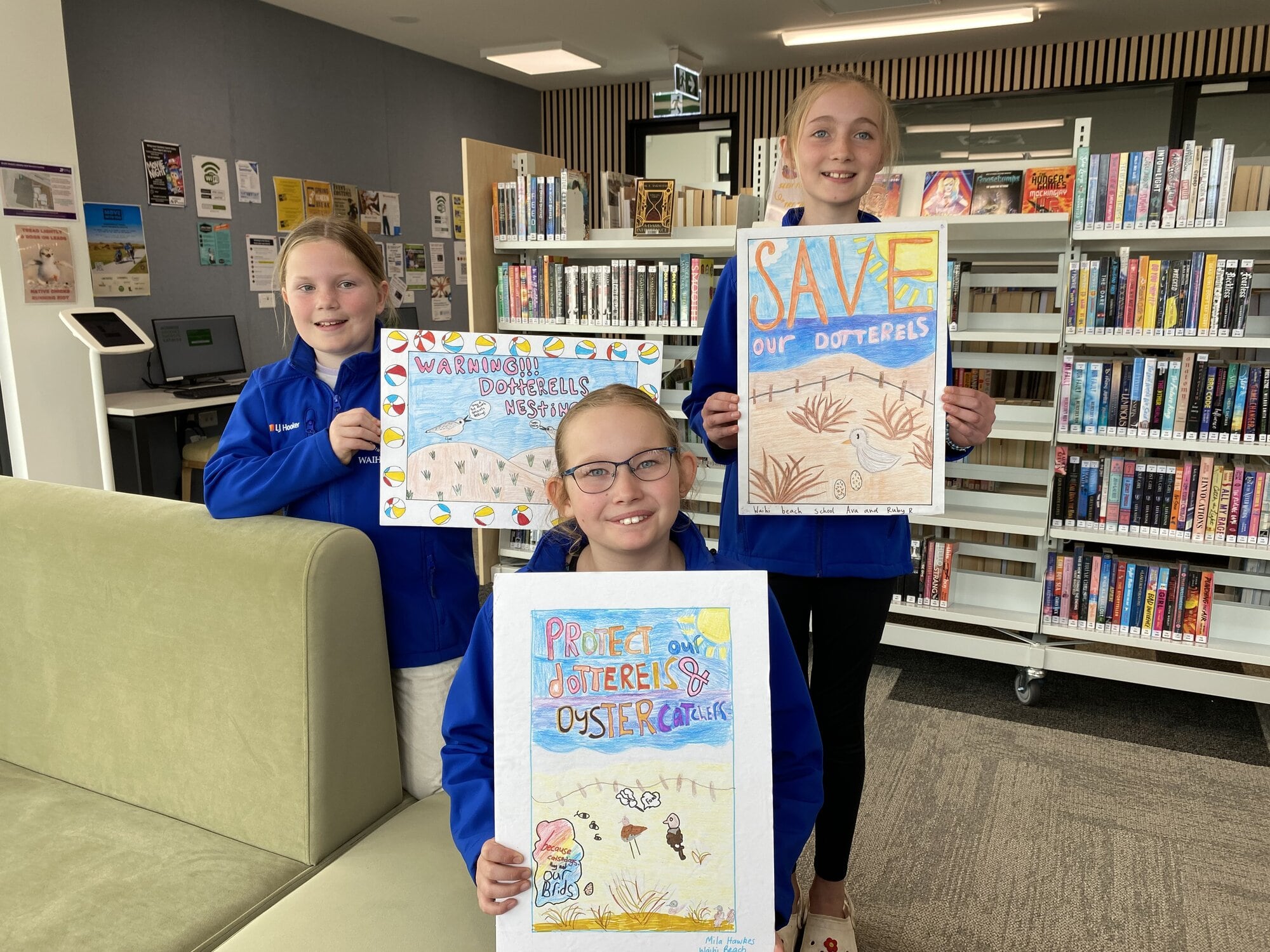  From left:  Waihī Beach School pupils Ella Pratt, 11, Mila Hawkes, 11 (in front), and Ruby Richards, 11 who created her poster with Ava Estreich, 11. Photo / Rosalie Liddle Crawford