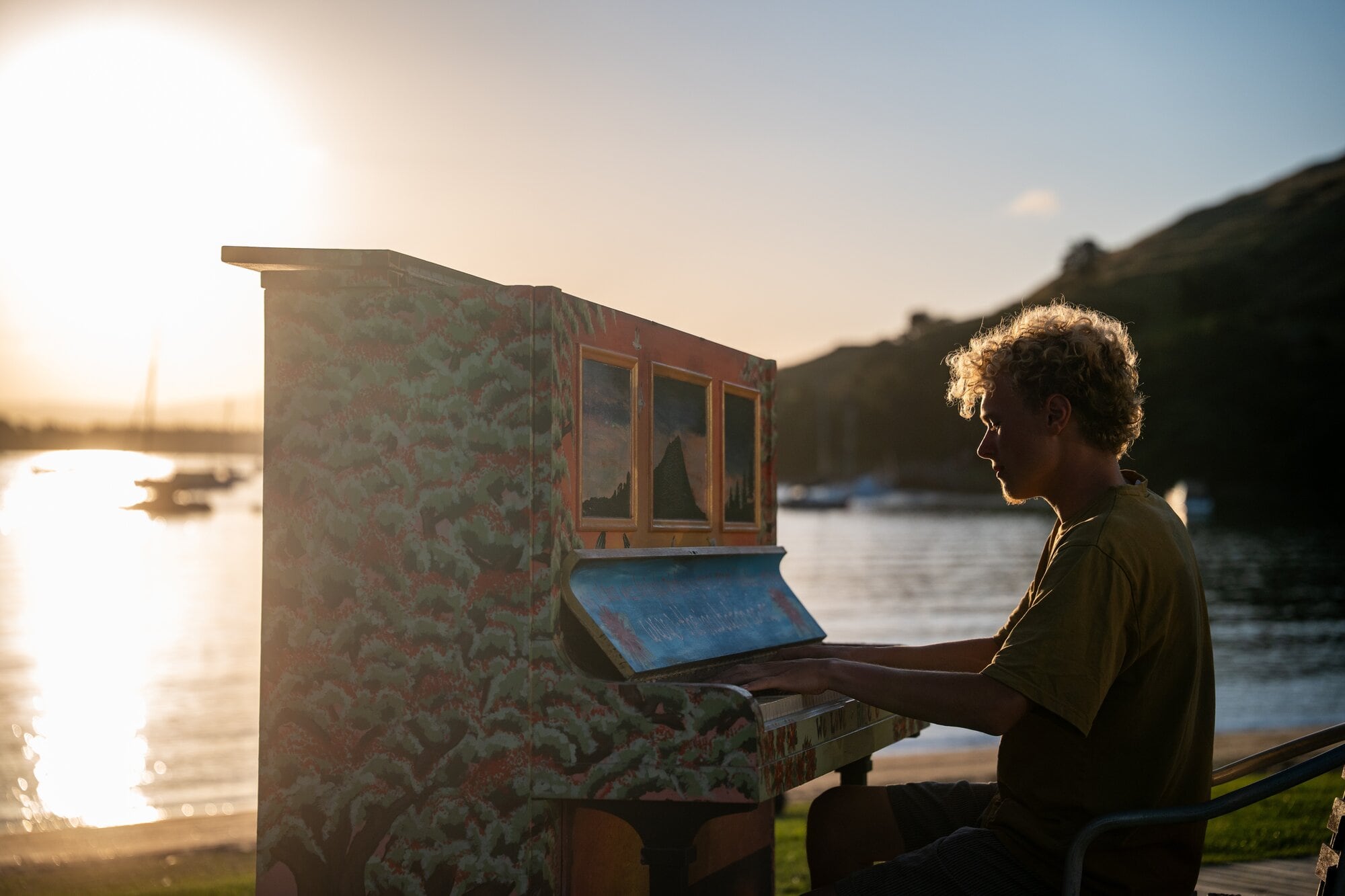 Harry Carpenter playing the Mount Maunganui beach piano in Pilot Bay. Photo / Corey Fleming