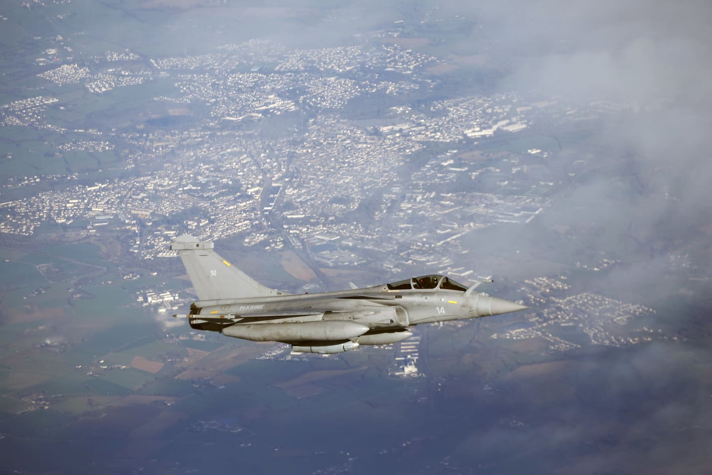 A French Air Force Dassault Rafale B aircraft escorts an Airbus A330 refuelling aircraft transporting France's President during a flight display, moments before landing at the Nuclear Submarine Navy Base of Ile Longue in Crozon, north-western France today. Photo / Yoan Valat, Pool via AFP