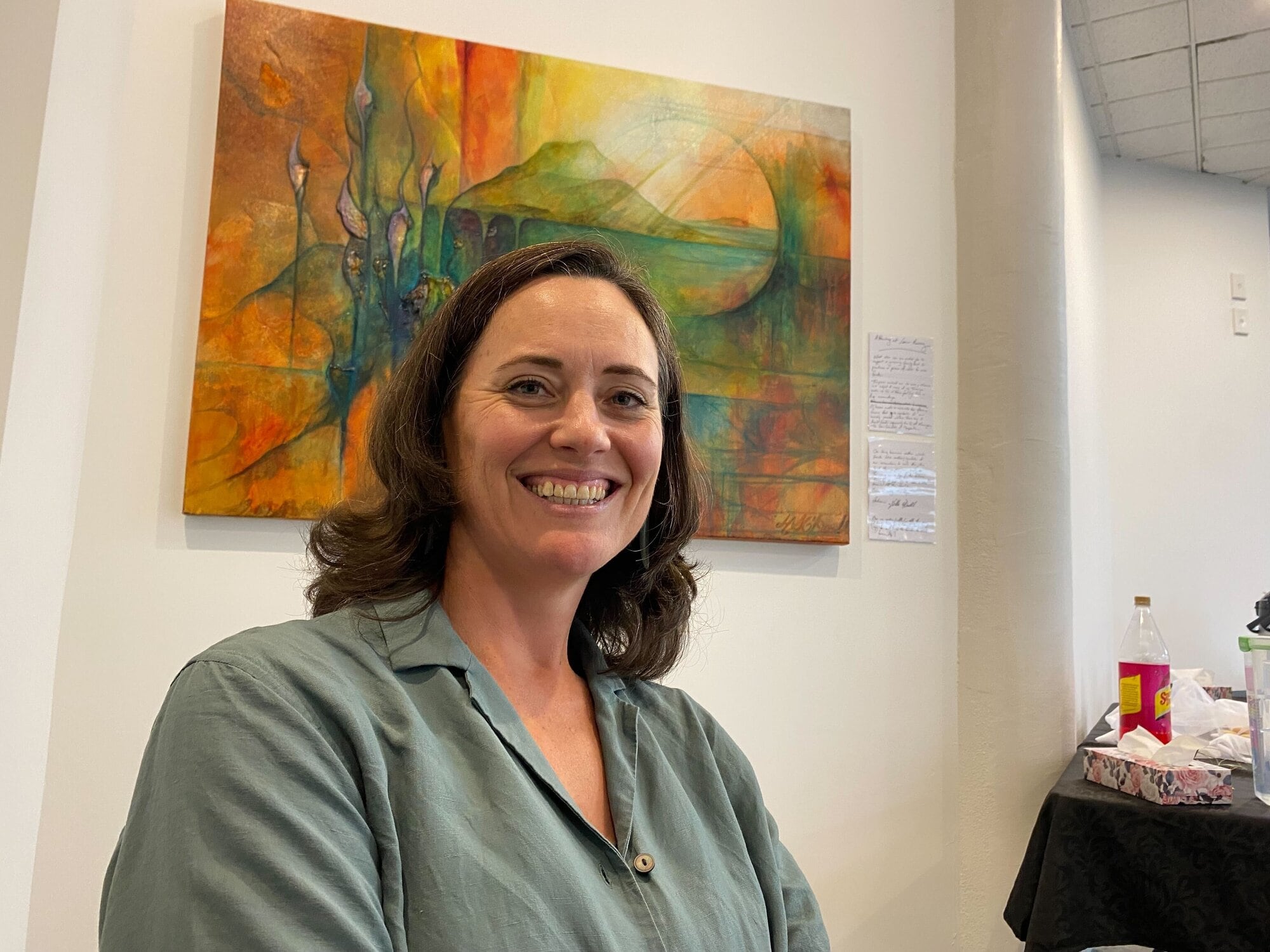Sarah Spence at a table of flower essences which are being offered to support people in crisis. Photo / Rosalie Liddle Crawford