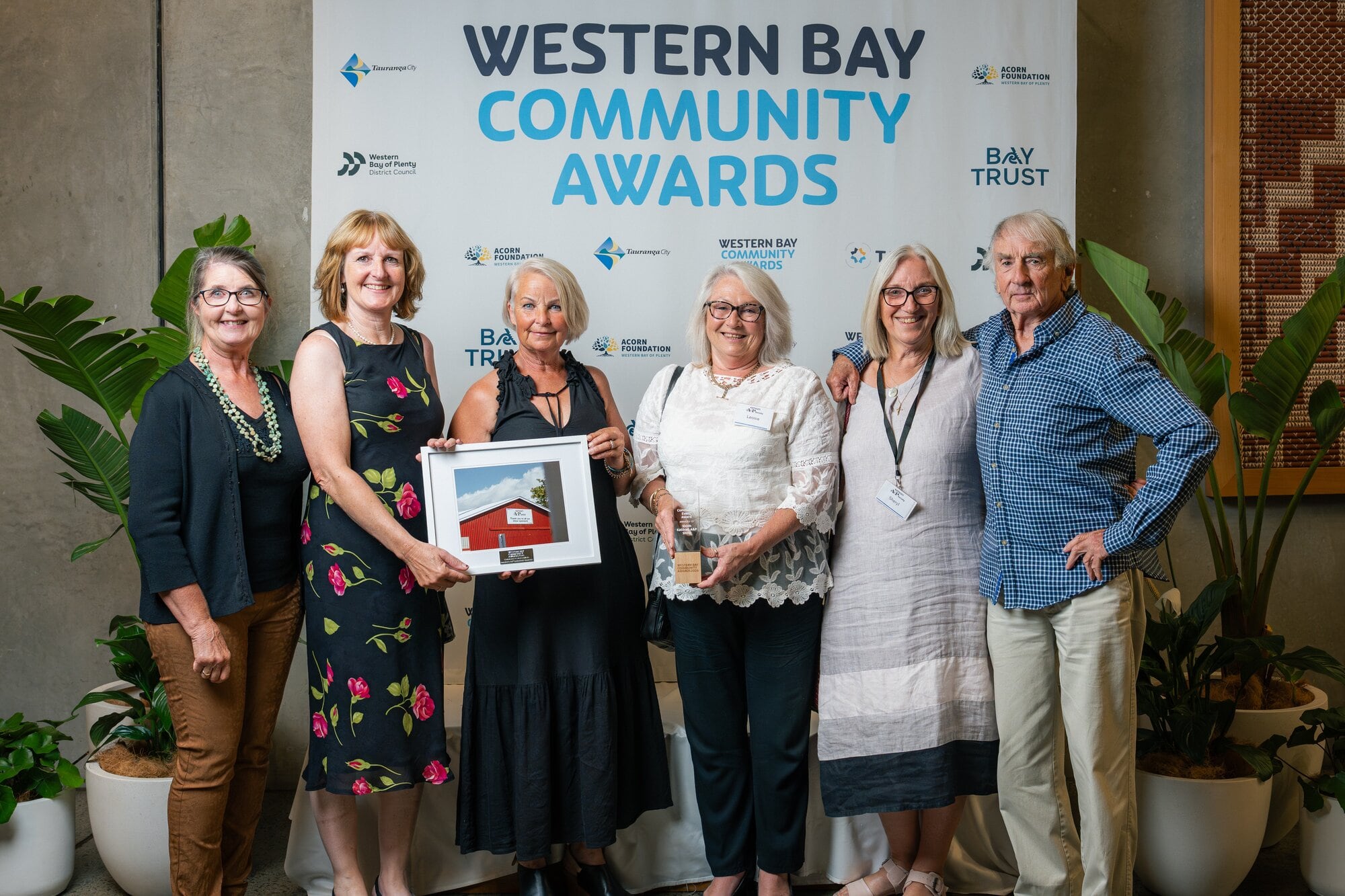  Katikati A&P Show Committee members Dawn Mellow, Sally Goodyear, Maree Clothier, Leonie Alder, Sheryl Smith and Phil Christopherso with the Community Event Award trophy. Photo / Studio Muse - Shal Addis Photographer