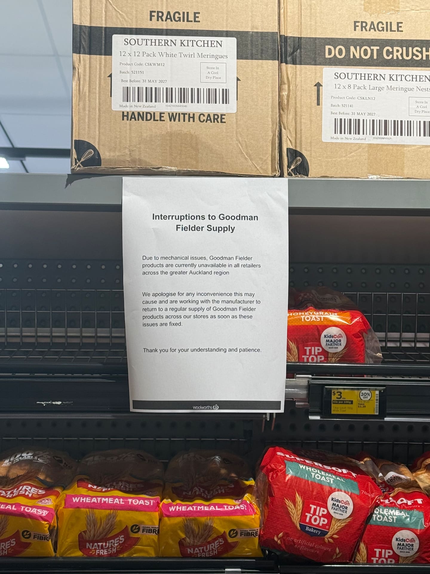 A notice advising shoppers of bread shortages at Woolworths this morning. Photo / NZ Herald
