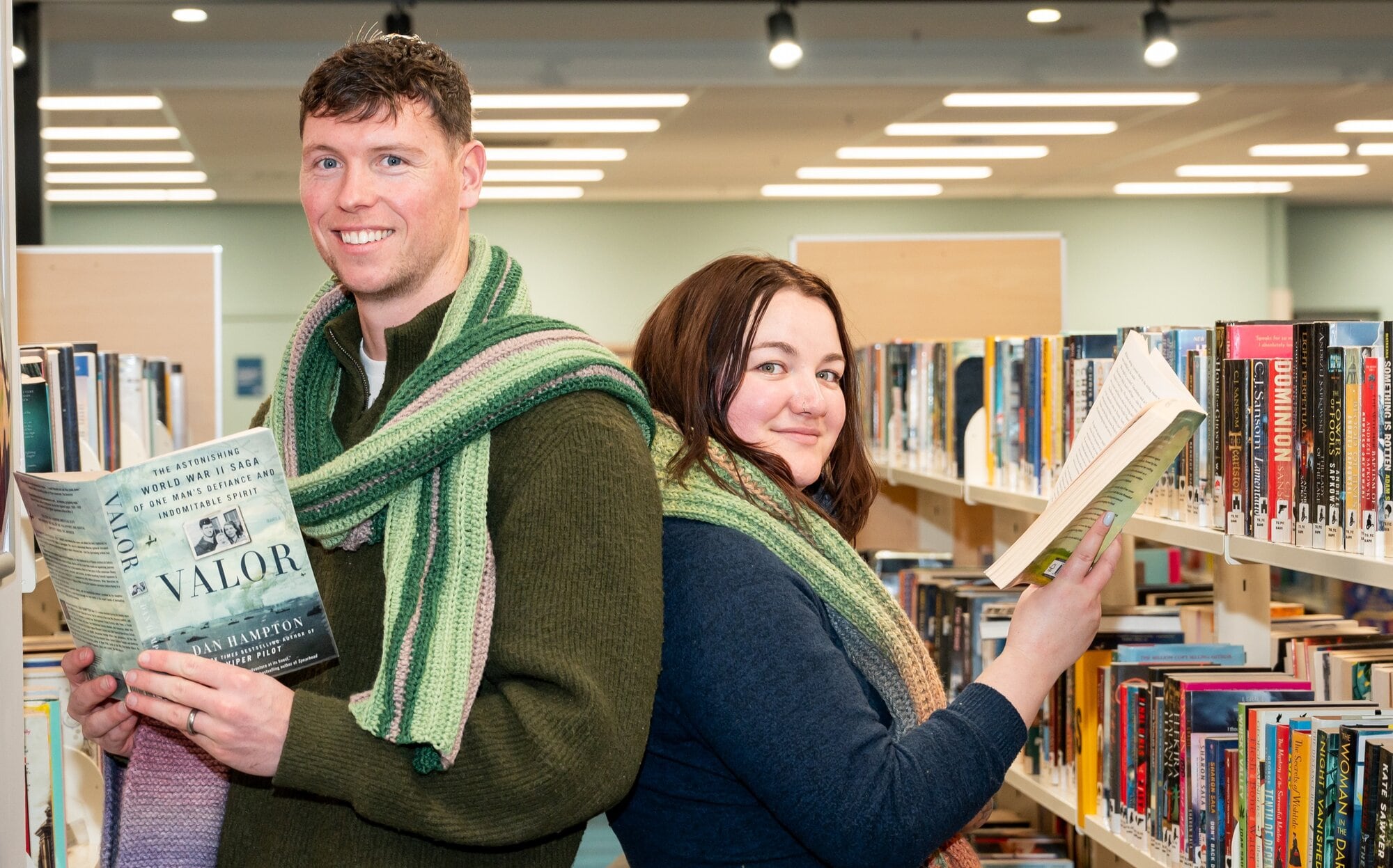 Helping collect scarves are Tauranga Library Community Hub team leader Brad Fuller and library assistant Caitlin Bowkett. Photo / Brydie Thompson