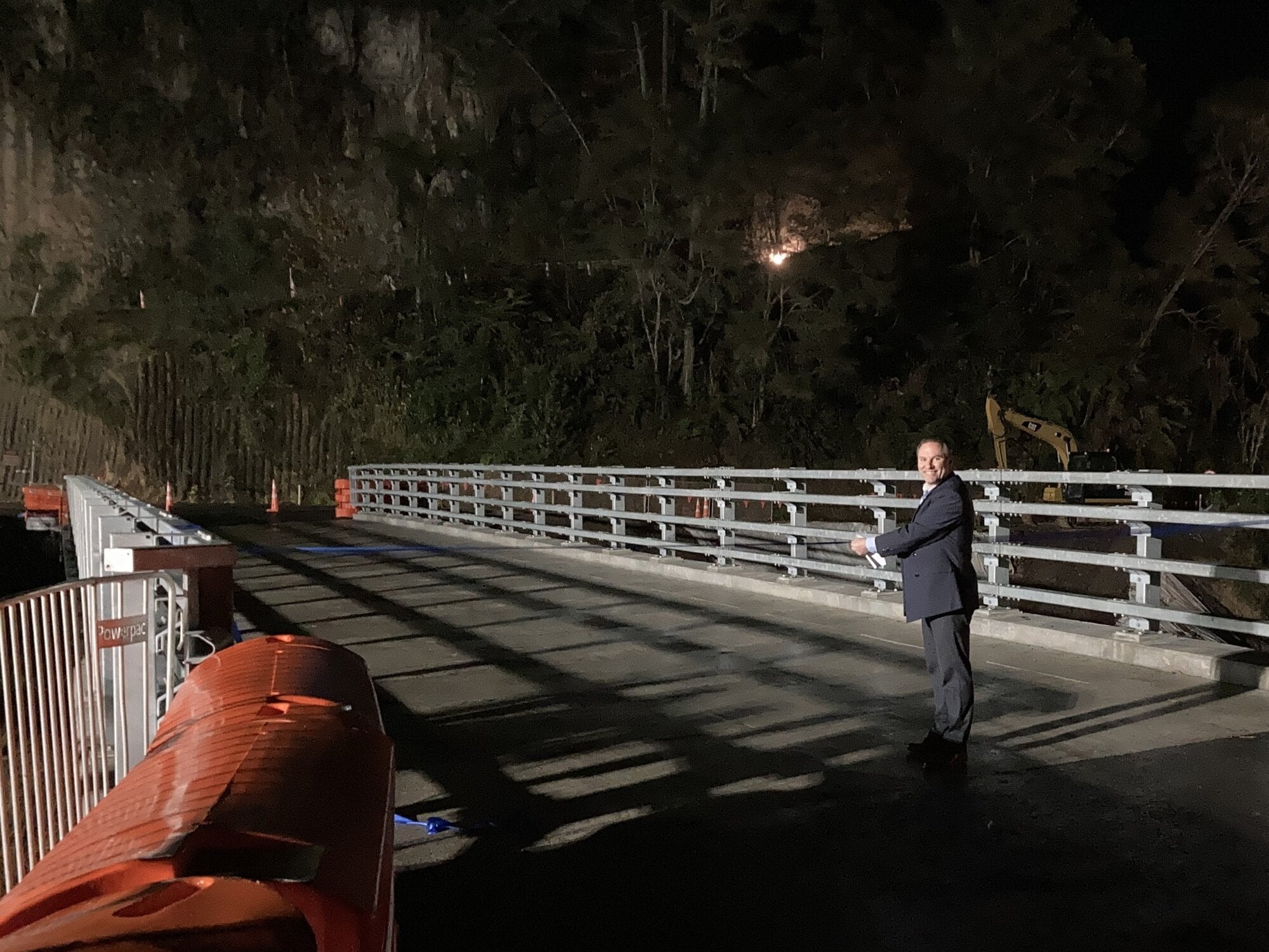 Western Bay Mayor James Denyer cuts the ribbon at a dawn ceremony to declare the bridge open.  Photo / Beca