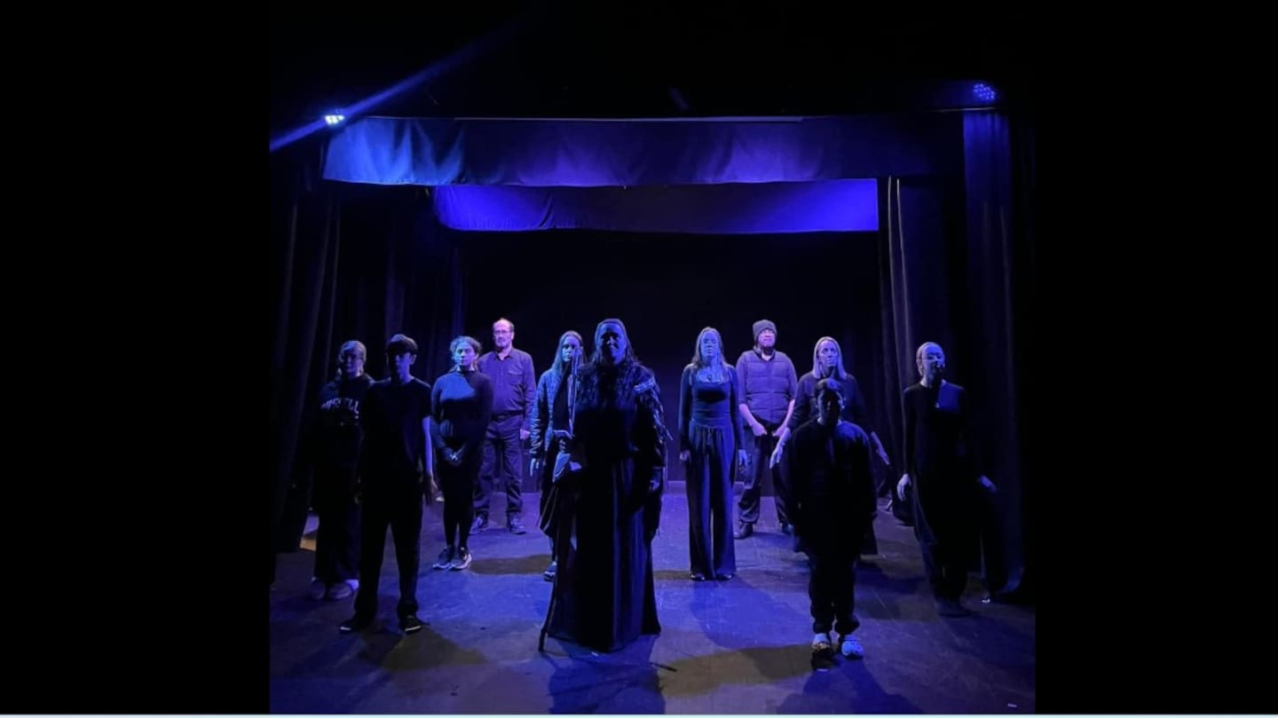 Mike Collins, spot lit on the left of the back row, in one of more than 40 Dargaville Little Theatre productions in which he appeared over the years.