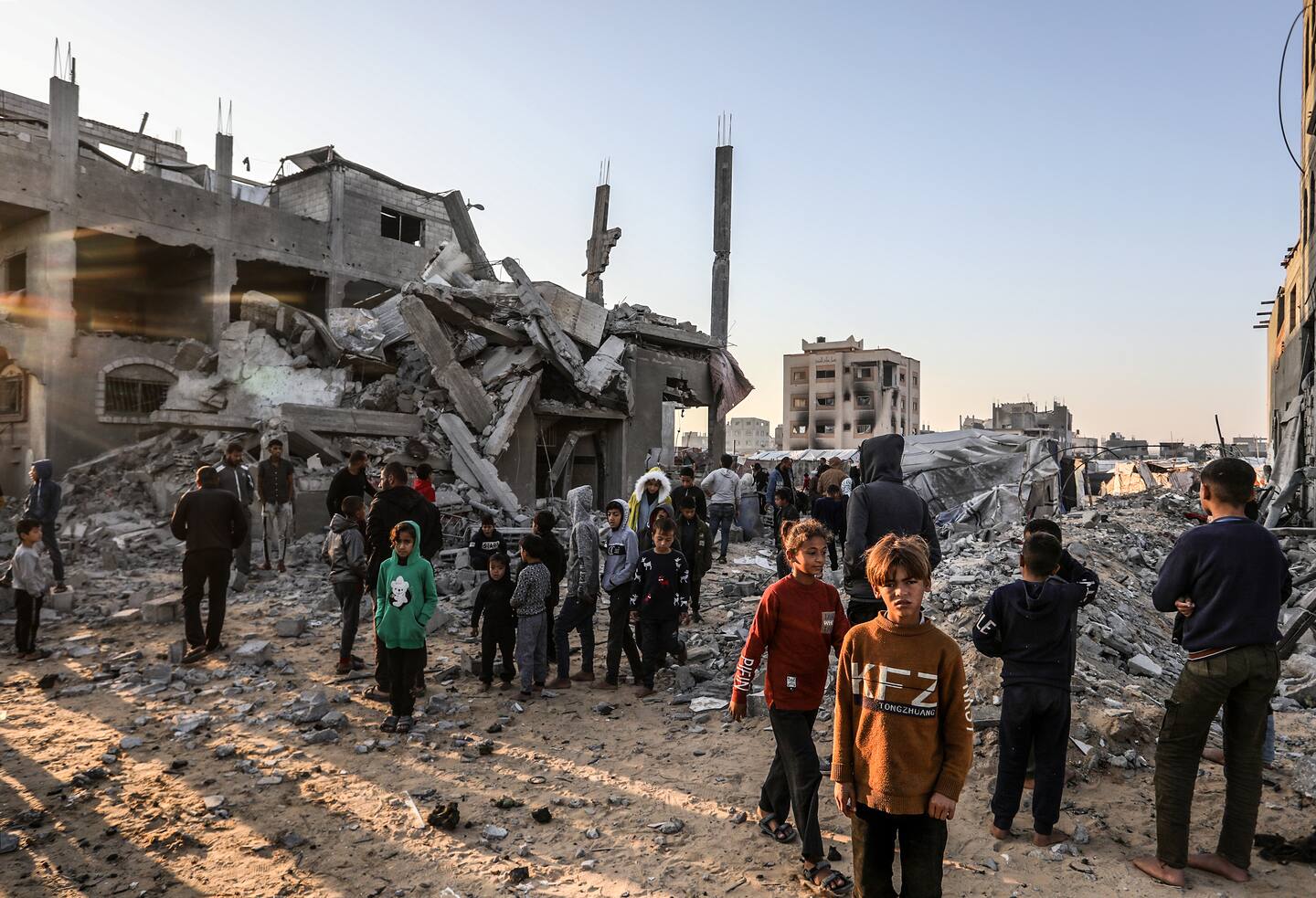 Palestinians gathered among the damaged buildings and vehicles after the Israeli attacks on a house belonging to the Abu Sible family in al-Mawasi area, in the west of Khan Yunis, Gaza on November 23. Photo / Getty Images