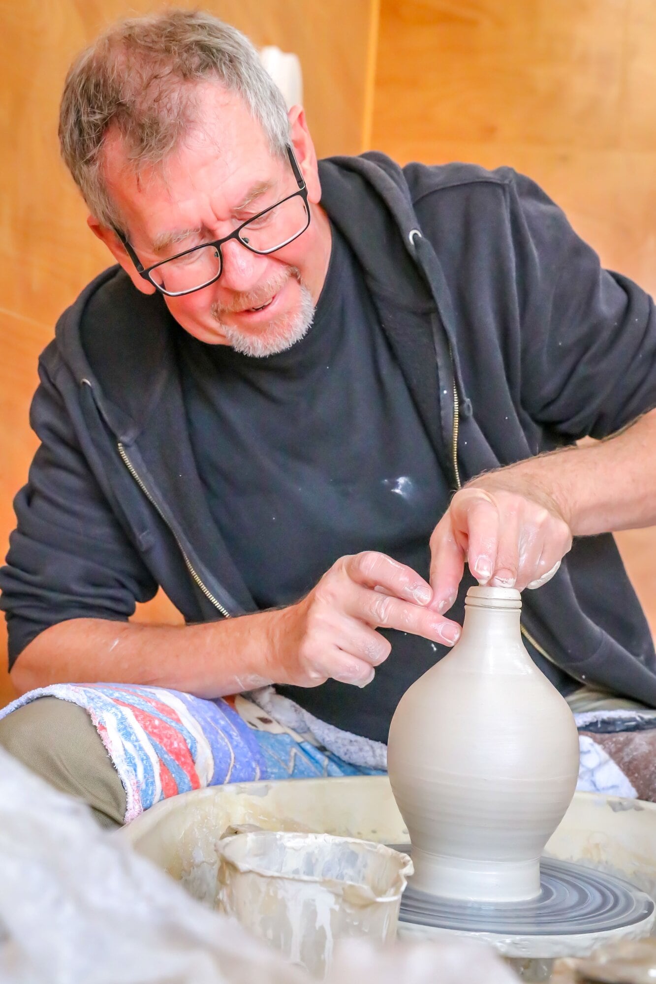 Artist Nick Eggleston at work on the pottery wheel creating a pirate-themed bottle. Photo / Kelly O’Hara