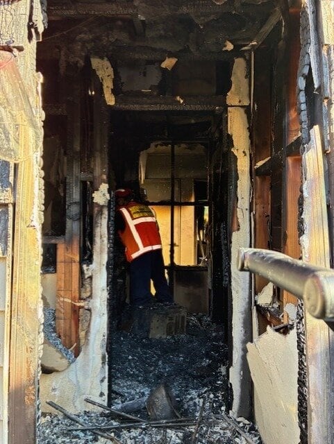 A Fire and Emergency New Zealand investigator at the scene inside the fire-damaged home.
