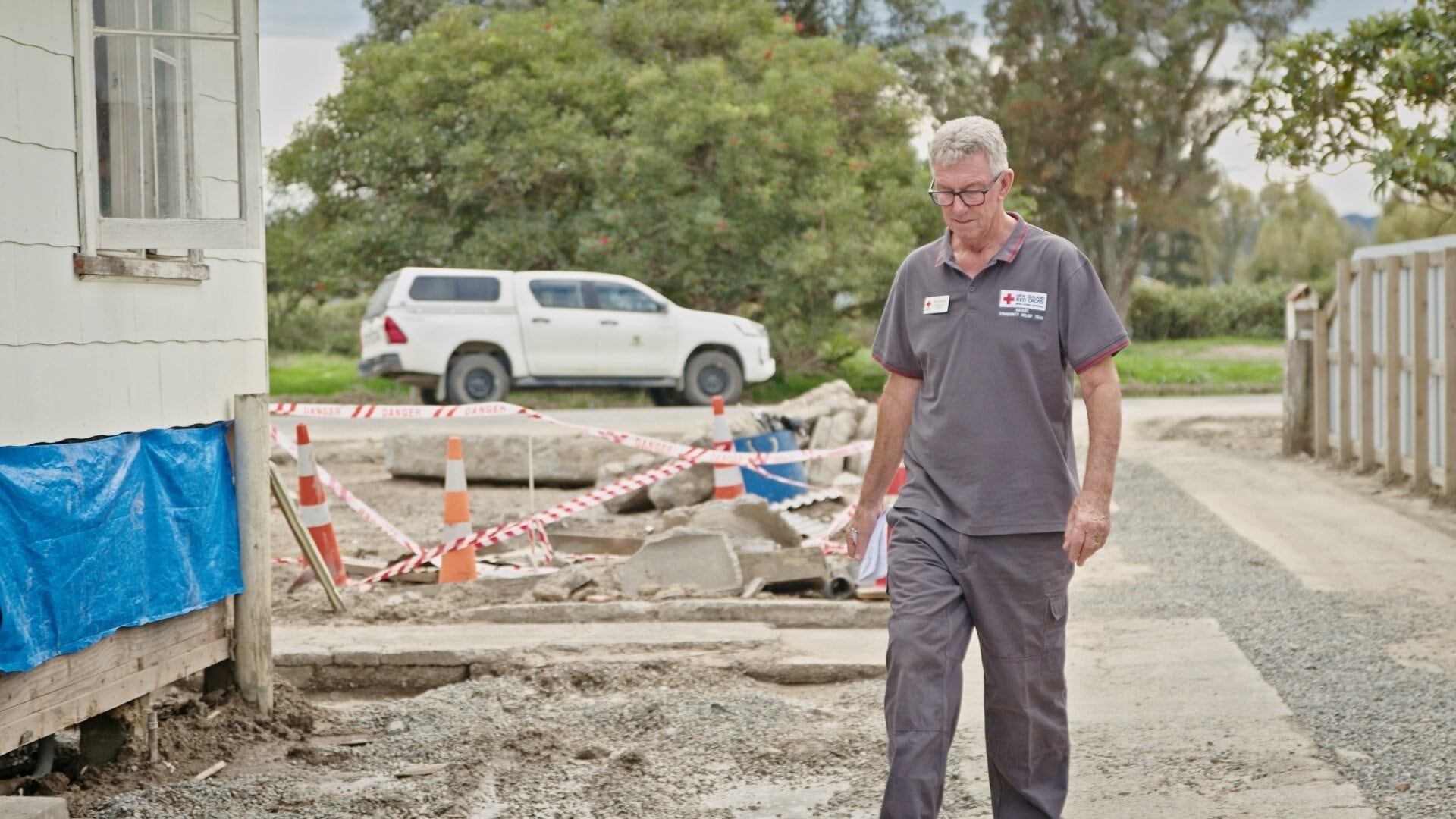 New Zealand Red Cross regional project manager for Tarawhiti and Wairoa, Phil Parker visits a yellow stickered home in Wairoa back in 2023. Photo / NZ Red Cross. 
