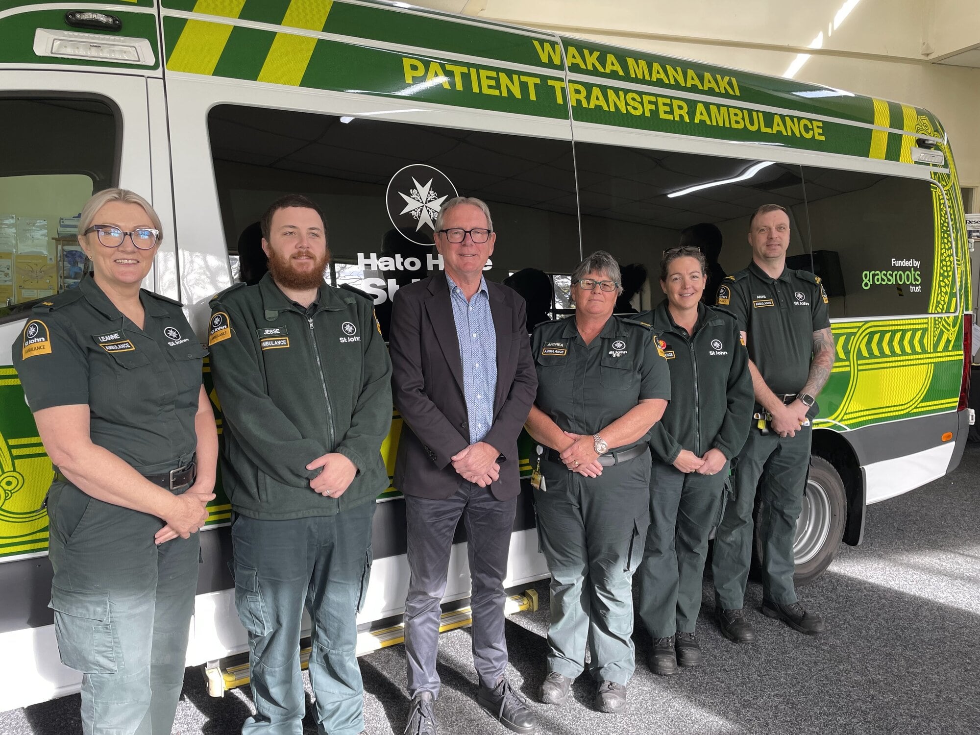 Leanne Mckinnon, and Kevin Burgess (third from left), with local HHStJ patient transfer service operations staff. Photo / Supplied