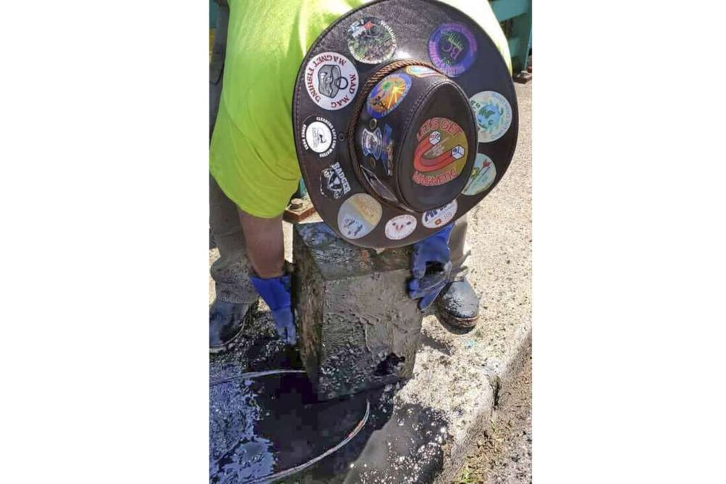 James Kane examines a safe he pulled out of the pond. Photo / AP