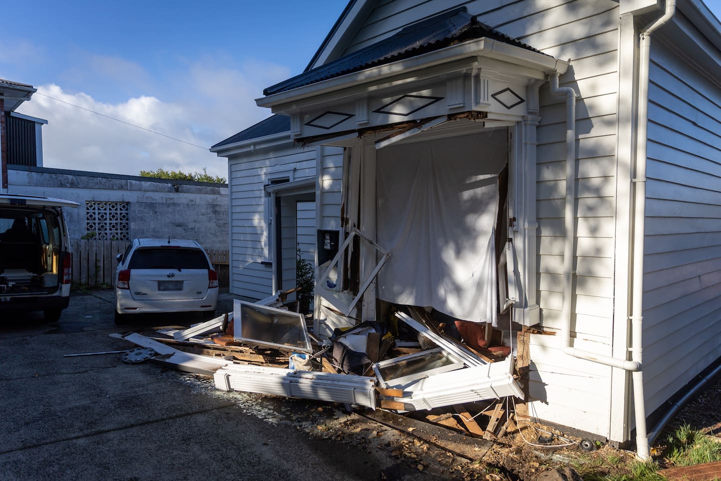 Two homes suffered extensive damage after a car smashed into the Massey properties overnight.  Photo / Michael Craig