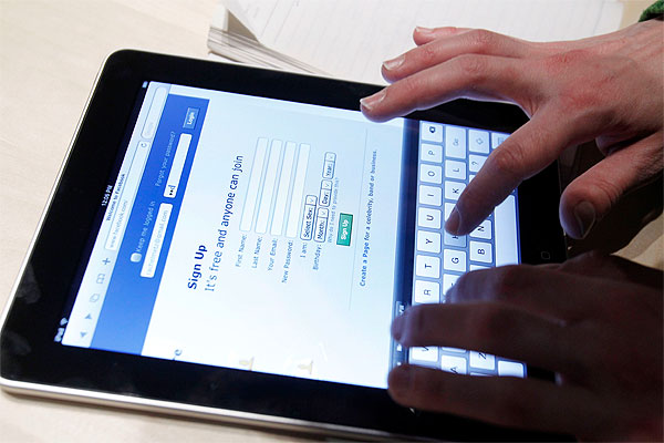Typing on the onscreen keyboard of the iPad. Photo / AP