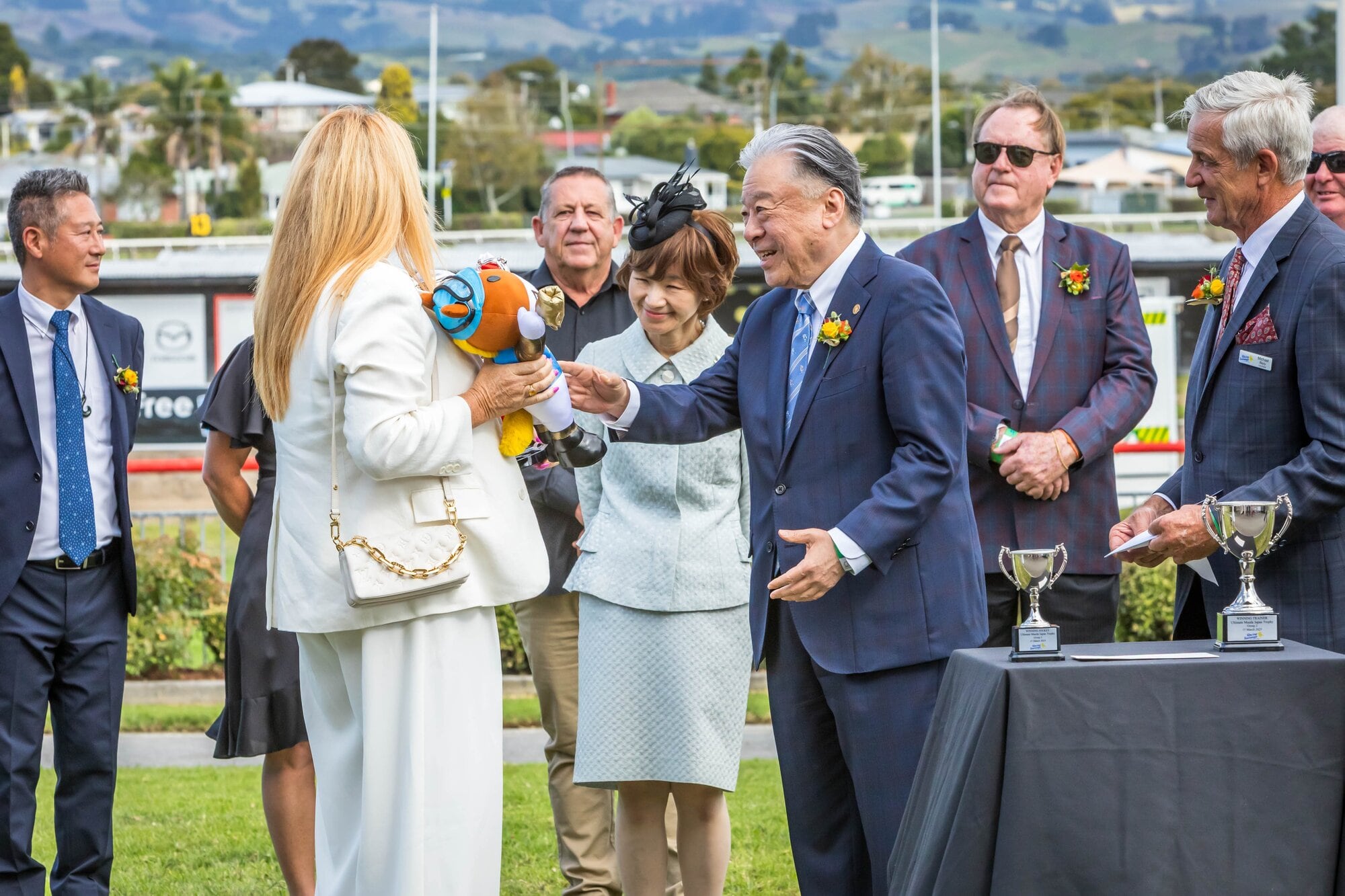 The connections of Waitak pictured receiving the trophy from a JRA rep.
