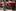 People dressed as elves and men in Father Christmas outfits from the London Santa School cross a road in London. Photo / AP