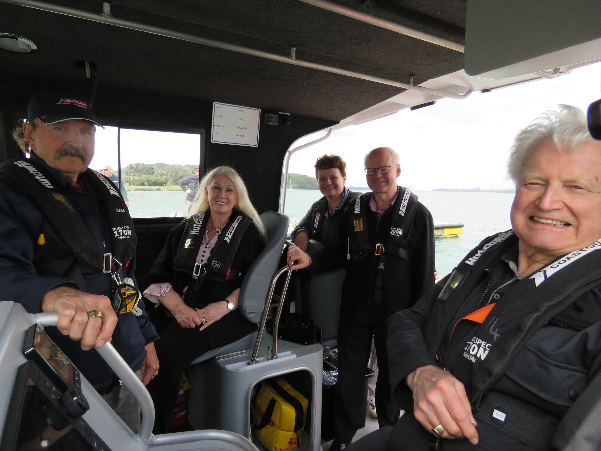  Waihī Beach Coastguard president Sam Dunlop, Lady Judi Gallagher, crew members, and Sir William Gallagher on-board the new vessel. Photo / Merle Cave