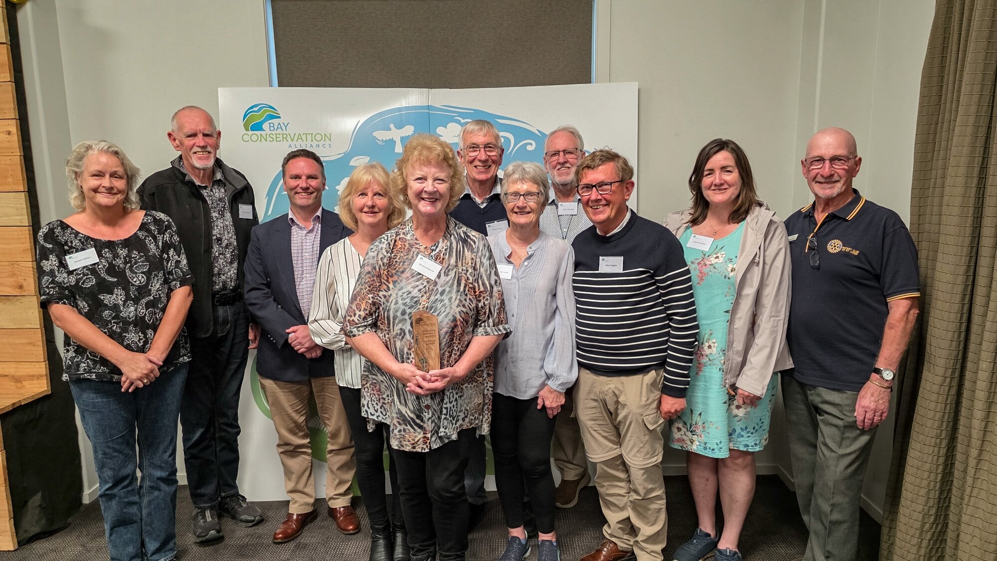 Awarded for her outstanding contribution to conservation in the Bay of Plenty, Christina Cleaver from the Ōmokoroa Bird Group holds her trophy, surrounded by others from Ōmokoroa Environmental Managers Inc. Photo / Supplied