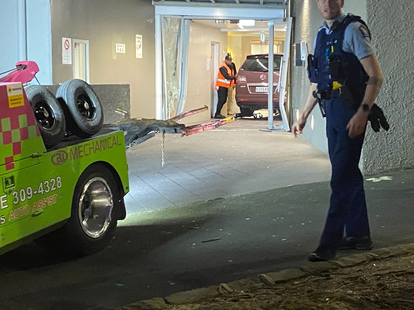 Efforts were under way to remove a car after it crashed into a building on Vincent St, central Auckland, this evening. Photo / John Weekes