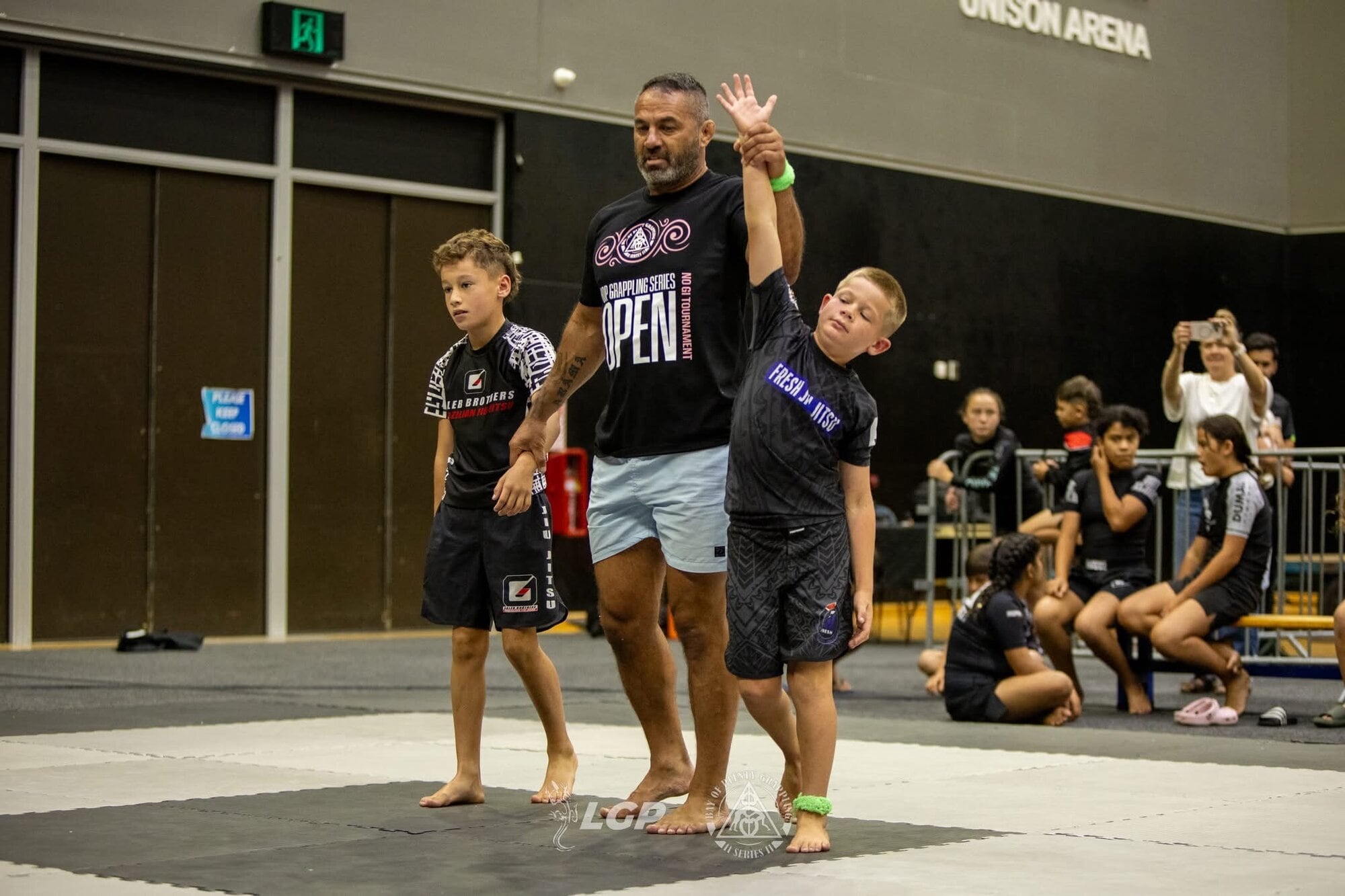 Joe Mathis, 9, has his hand raised as the winner.
