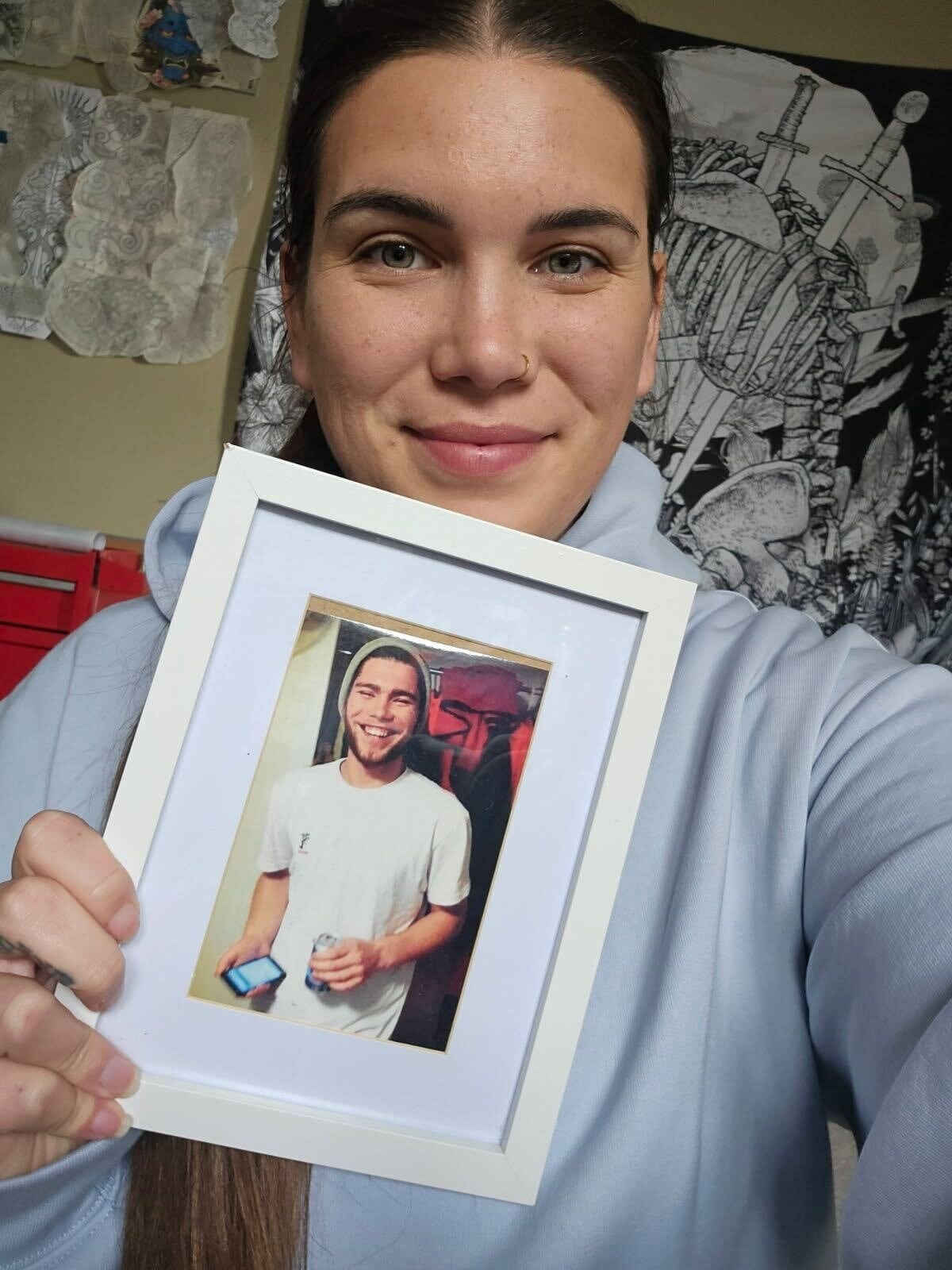 UnderTongue Tattoo co-owner Alysia Greaney with a photo of her brother Dylan Greaney, who she lost to suicide when he was 19 on December 1, 2019.