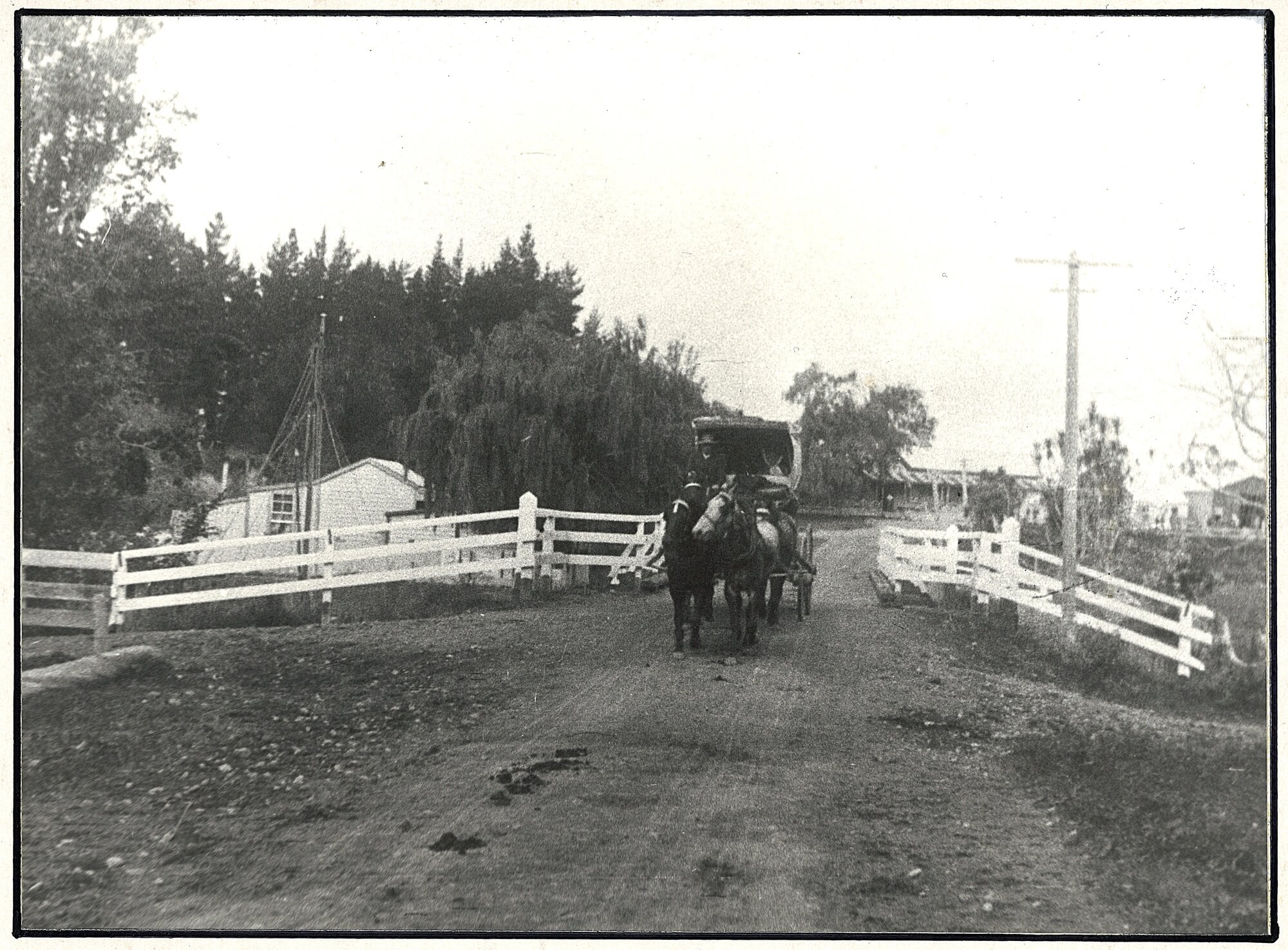  The Tauranga-Waihi Royal Mail coach crossing the Uretara bridge on its way to Waihi. The Talisman Hotel can be seen in the background. The building on the left, removed about 1960, was the home, shop and workshop of electrician Bert Ruby. The photo was taken by Frederick George Radcliffe circa 1913. Photo / Western Bay Community Archives Collection
