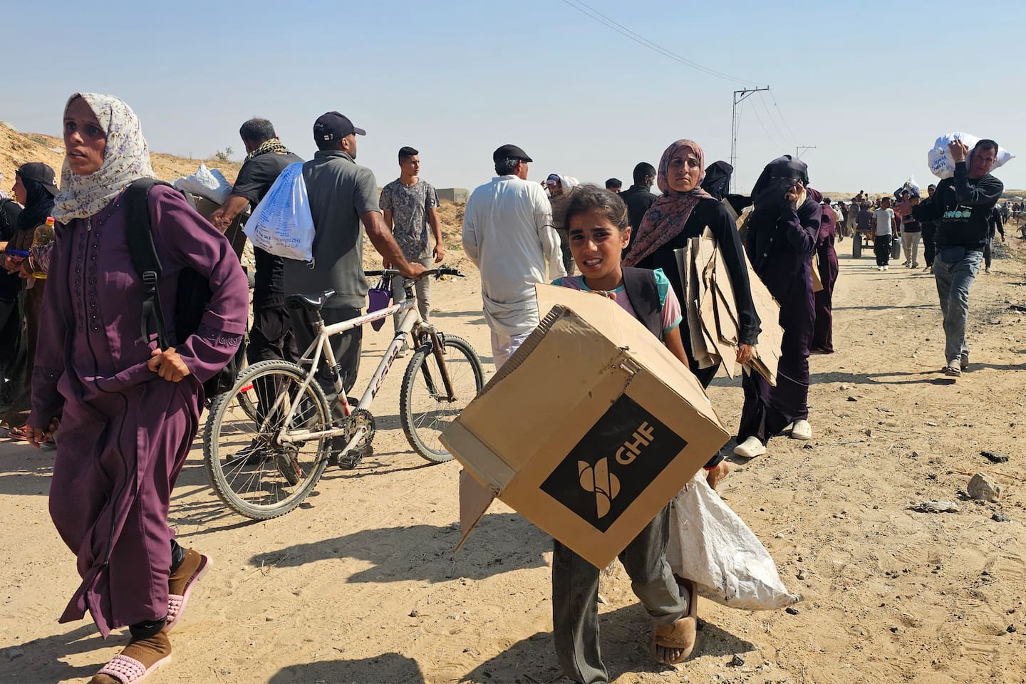 Displaced Palestinians walk to receive humanitarian aid packages from a US-backed foundation in Rafah in the southern Gaza Strip. Photo / AFP