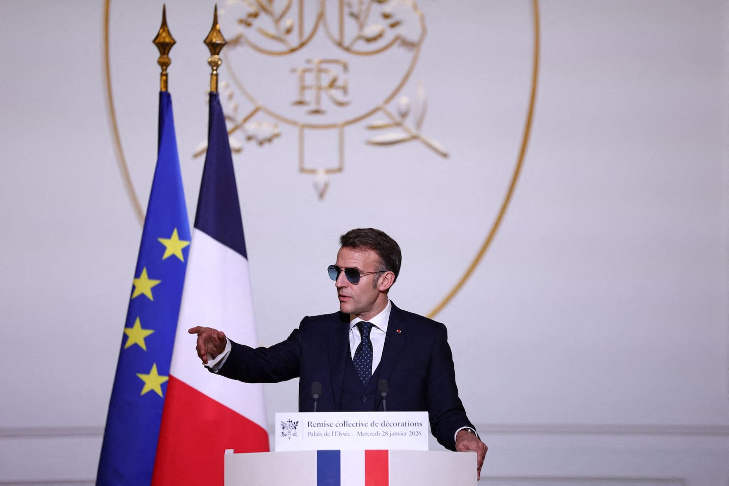 French President Emmanuel Macron, wearing sunglasses, delivers a speech during a ceremony to award the Chevalier of the French Order of Merit to Ali Akbar. Photo / Tom Nicholson, POOL, AFP