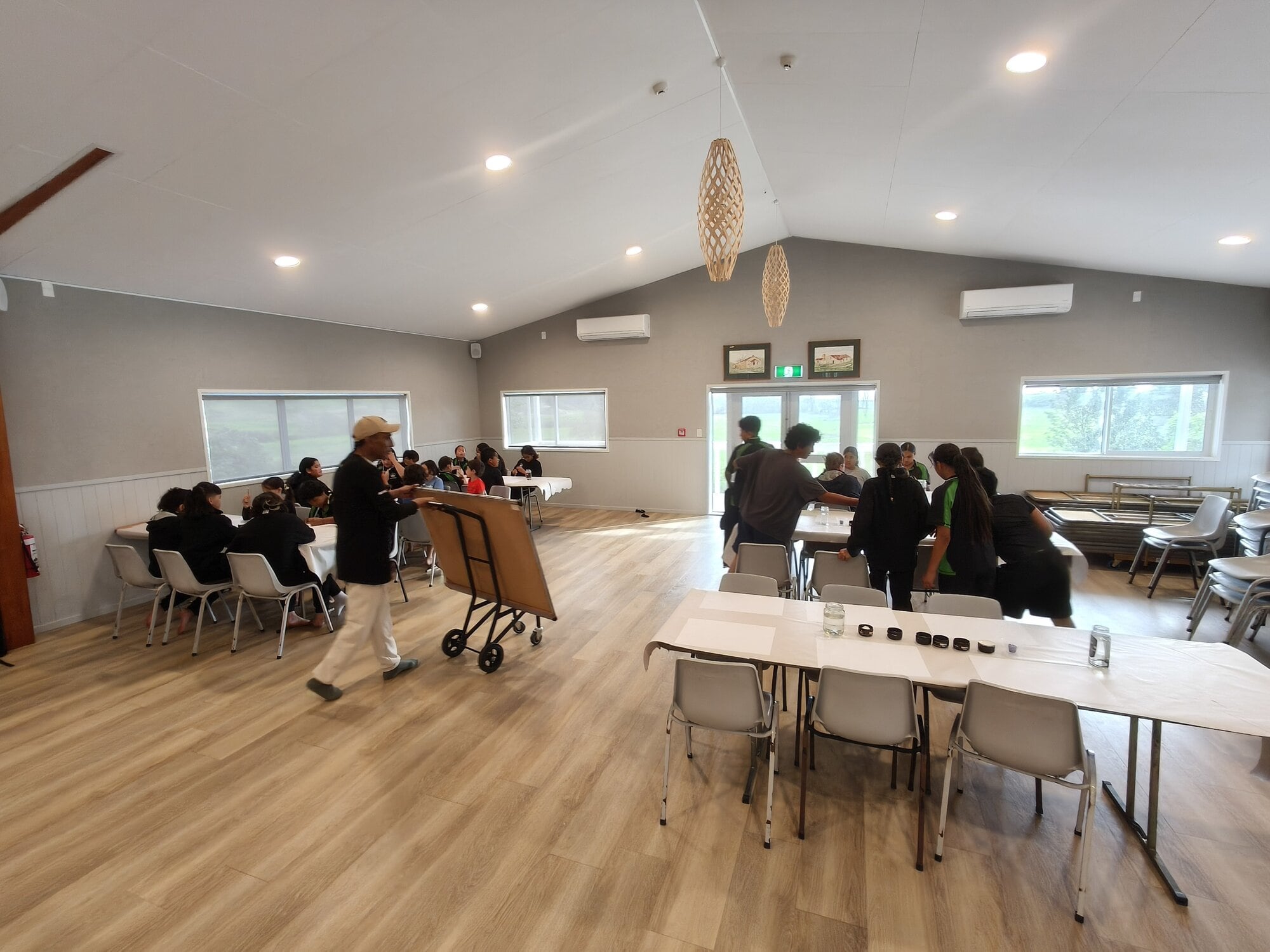 Tutor Noel Rakuraku teaches children a basic kōwhaiwhai pattern at Waiaua. Photo / Supplied