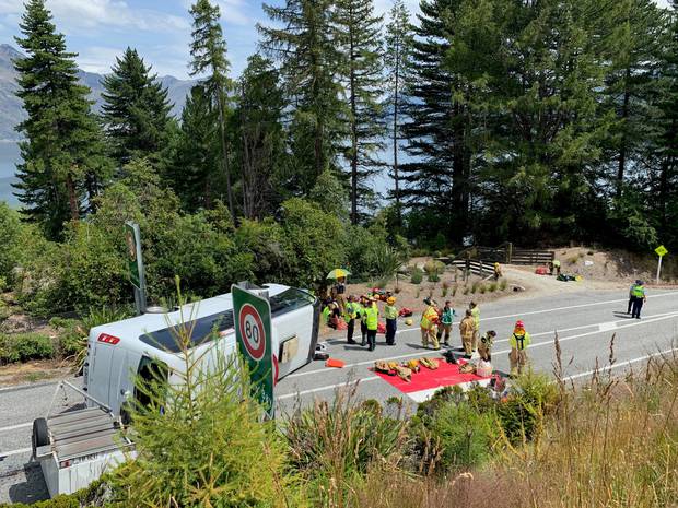 Emergency services workers tend to the injured. Photo / James Allan