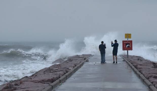  Josue Blanco, left, and Alex Mendez photograph waves generated by Hurricane Laura as they crash into the rock groin at 37th Street in Galveston, Photo / AP