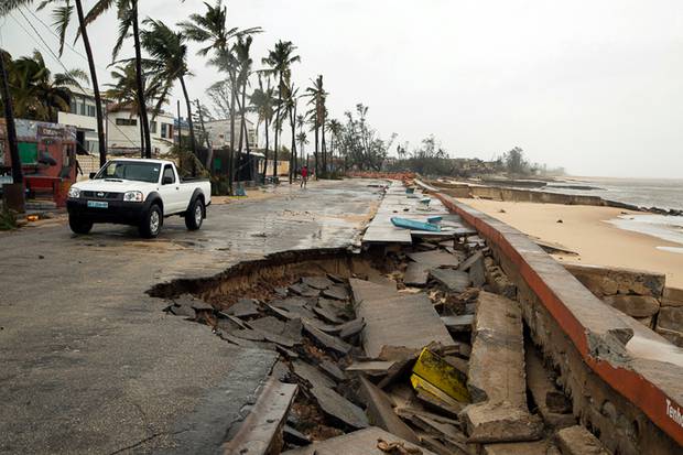 A car drives past a destroyed section of the road after Tropical Cyclone Idai hit land in Beira, Mozambique. Photo / Red Cross, via AP