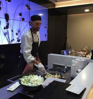 A chef whips up some dishes in Air New Zealand's Koru Lounge. Pic Greg Fleming