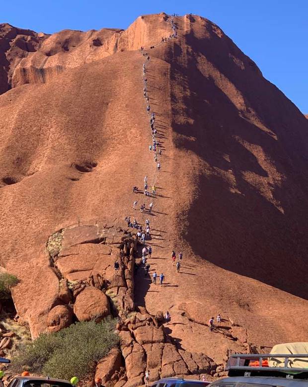 A photo of tourists climbing Uluru has left traditional landowners furious. Photo / Supplied