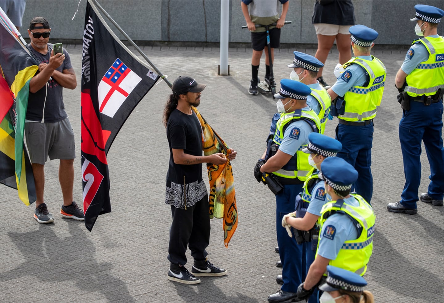 A protester speaks to police outside Parliament. Photo / Mark Mitchell